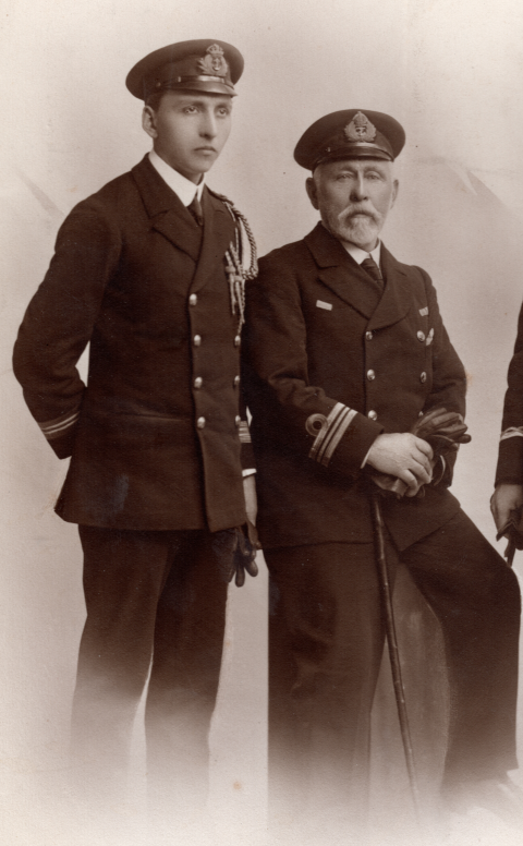 Victor Eason in his early 20s in naval uniform, and his father Henry also in naval uniform.